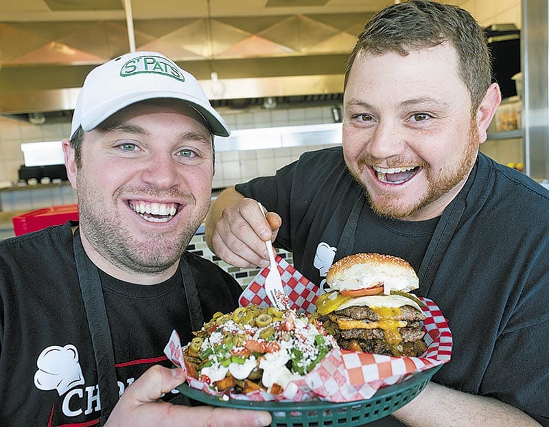 Greg and Chris Skillas with a triple custom hamburger with feta fries.